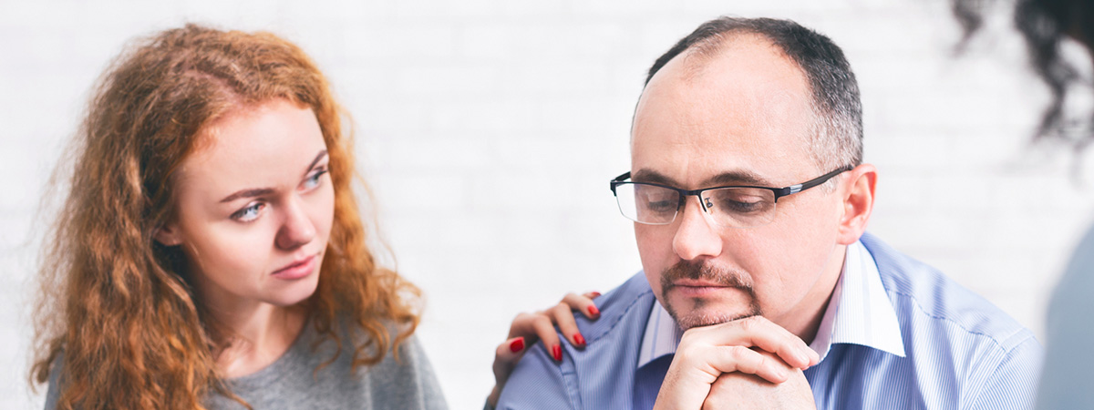  Supportive wife comforting husband with TRD during a meeting with a counselor in Robbinsville .
